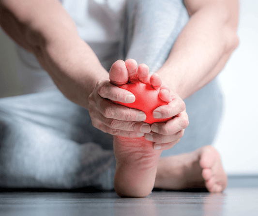 person-holding-foot-with foot-pain-10-common-causes-of-foot-pain